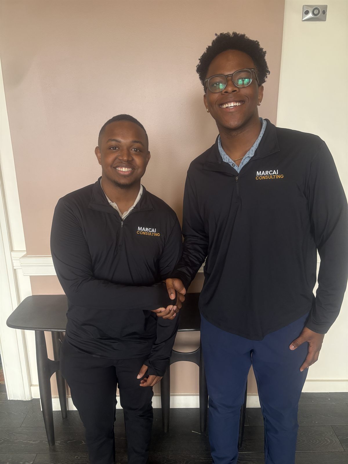 Two Marcai partners in branded apparel shaking hands.